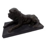 A bronze model of a recumbent mastiff dog, on a black slate rectangular plinth. (Dimensions: