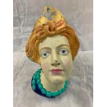 A reproduction carved wood female head, of ship's figurehead type, with painted detail and a