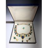 An 18ct gold Egyptian style suite, comprising a necklace, earrings and a ring. The necklace set with