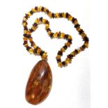 An amber chip necklace with a large amber drop which measures 7.3 x 3.8cm.