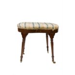 A Victorian mahogany piano stool, the floral decorated upholstered seat on turned tapering legs. (