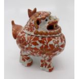 A Japanese Kutani porcelain incense burner in the form of a dog of foe, late 19th century, red