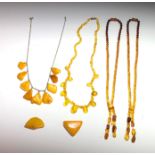 Four amber necklaces and two small pieces of amber, the largest maximum length 4.7cm.
