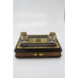 A walnut and ebonised desk stand, late 19th century, fitted with two brass topped ink bottles and