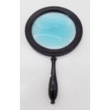 A Georgian ebonised magnifying glass. (Dimensions: Height 23.5cm overall) (Qty: 1)(Height 23.5cm