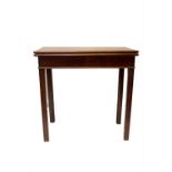 A George III mahogany tea table, the fold over top on square chamfered legs. (Dimensions: Height