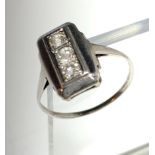 A 18ct white gold three stone diamond Art Deco ring.
