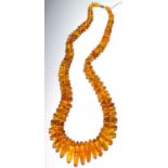 An amber submarine bead necklace, length 74.5cm.