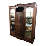 An Edwardian inlaid mahogany triple wardrobe. (Dimensions: Height 228cm., width 183cm.)(Height