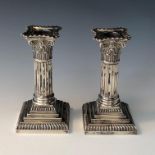 A pair of Goldsmiths Company filled silver Corinthian column candlesticks, height 14cm.Condition