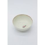 An 18th century English porcelain bowl, polychrome painted with floral sprigs, and with red line