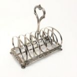 A good Victorian silver toast rack with heart shaped handle and scrolling bracket feet, by