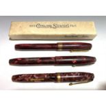 Three Conway Stewart red pens, numbers 84,36 and 15 (one boxed)