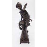 A bronze figure of a fairy seated on a column, signed. (Dimensions: Height 33cm.)(Height 33cm.)