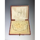 A silver mounted ivory brooch decorated with acorn branches, 7.8 x 5.2cm in a Vickery, Regent St red
