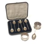 A set of six cased silver coffee spoons, two silver napkin rings and a silver bowling teaspoon,