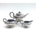 A good late Georgian three piece silver tea service by Jonathan Hayne with ornate floral decoration,
