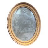 A small giltwood oval mirror, with original mirror plate, 38 x 30cm.
