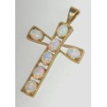 A 9ct cross set seven opals, length 5.1cm.
