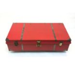 A red painted wooden trunk, the brass lock plate engraved 'AMERICAN, 6 LEVERS J.B FACTORY, CALCUTTA,