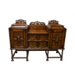 A Jacobean style oak sideboard, circa 1920's. (Dimensions: Height 119cm, width 154cm.)(Height 119cm,