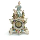 A German porcelain eight day timepiece, late 19th century, with flowers and applied figures. (