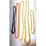 A graduated ivory bead necklace, length 75.5cm and four other beaded necklaces.