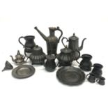 A collection of pewter to include a wine funnel, tankards, plates, tea and coffee pots, together