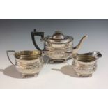 A Cooper Brothers three piece silver bachelor's tea service with engraved floral and acanthus