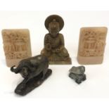 A pair of Chinese carved soapstone bookends, a soapstone figure of buddha, a buffalo and a bird (