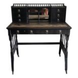 A good high Victorian ebonised writing table in the manner of Godwin, the back with a pair of