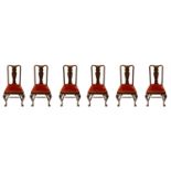 A set of six Edwardian mahogany dining chairs, each with a solid vase shaped splat, above a drop