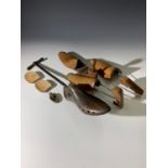 An antique shoe stretcher, a pair of wooden shoe trees, a single shoe tree/last, and two wooden heel