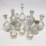 A collection of assorted cut glass decanters and other glassware.