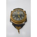 An unusual mystery wall timepiece, the shaped ebonised mount with applied gilt decoration, the black