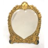 A magnificent silver gilt dressing table mirror by William Comyns the bevelled heart shaped plate