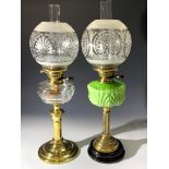 Two brass and glass oil lamps, early 20th century.