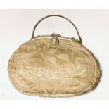Evening clutch purse in ivory silk overlaid with fine lace. Gilt metal frame and clasp embelished