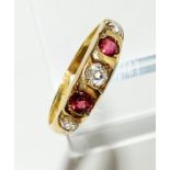 An 18ct gold five stone diamond and ruby ring, 4g.