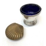 A brass shell shaped vesta case and a silver salt.