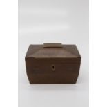 A George III mahogany tea caddy of sarcophagus form, the cover opening to reveal two lidded