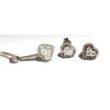 An 18ct. white gold diamond set heart pendant necklace and a pair of matching earrings. (Qty: 1)