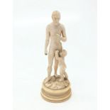 A 19th century ivory figure of a man and child, on a circular ivory plinth base. (Dimensions: Height