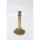 A late 19th century gilt bronze model of a lighthouse, the rocky base with inset steps. (Dimensions: