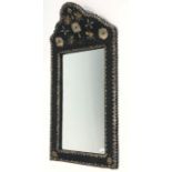 A Moroccan leather covered and metal mounted wall mirror. (Dimensions: Height 102cm, width 53cm.)(