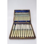 A set of twelve Victorian dessert knives and forks in oak case with velvet and satin lining.