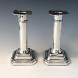 A pair of silver candlesticks.