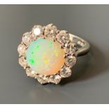 An 18ct white gold diamond and opal ring. Opal 10mm diameter.