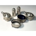 A 1920's pierced silver cruet comprising two open salts, two peppers and two mustard pots with