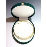 An 18ct gold collar with five white gold diamond studded bands, green velvet box.